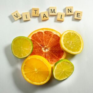 sliced citrus fruits and wooden scrabble tiles on a white surface
